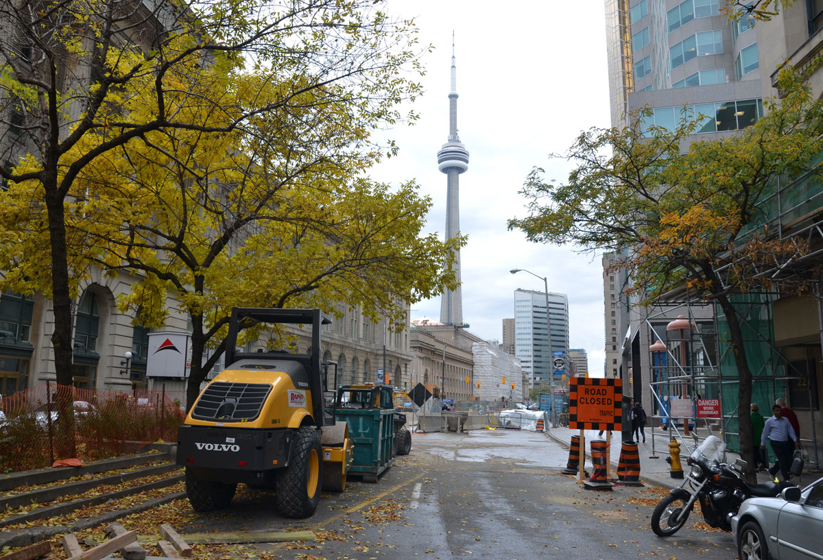 construction on a downtown street, with the CN tower in the background.  