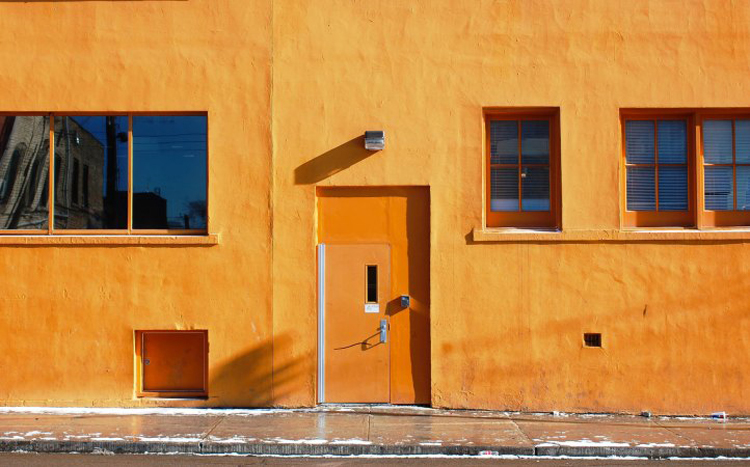 door and windows on a very bright orange wall