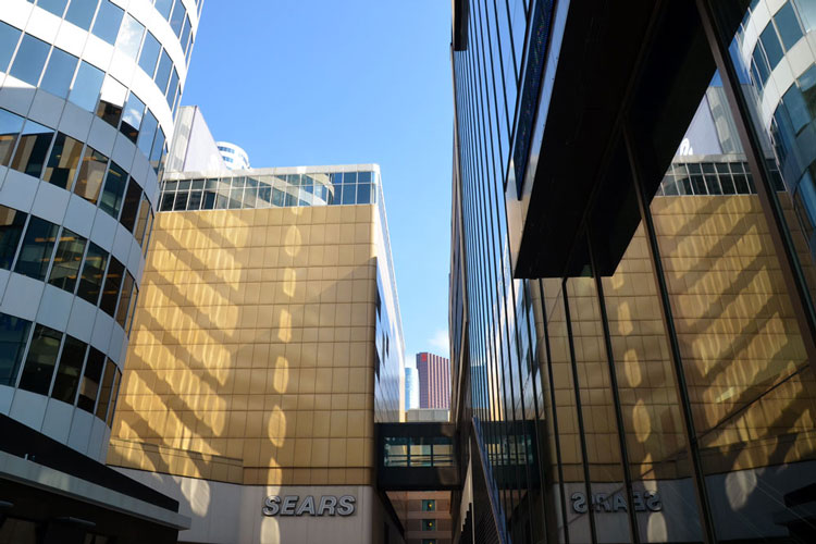 reflections in the windows of the north side of the Eaton Centre as seen from Dundas Street