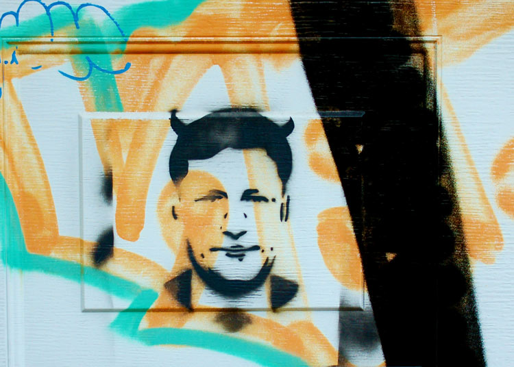 graffiti of Stephen Harper with black devil horns on his head