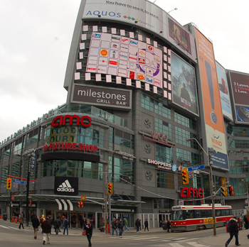 the northeast corner of Yonge and Dundas showing stores, billboards and crowds on the street
