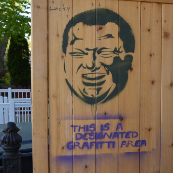 stencil graffiti showing a caricature of Rob Ford with the words This is a Designated Graffiti Area written underneath 