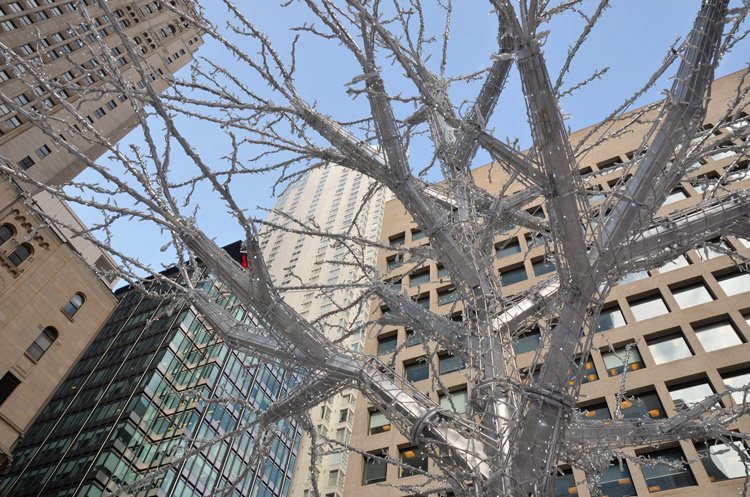 metal tree sculpture covered with Christmas lights