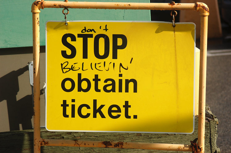 sign that once said stop and obtain ticket now reads don't stop believin'.