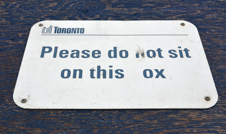 do not sit on this ox which should say box not ox.  Someone has scratched off the letter b in box.