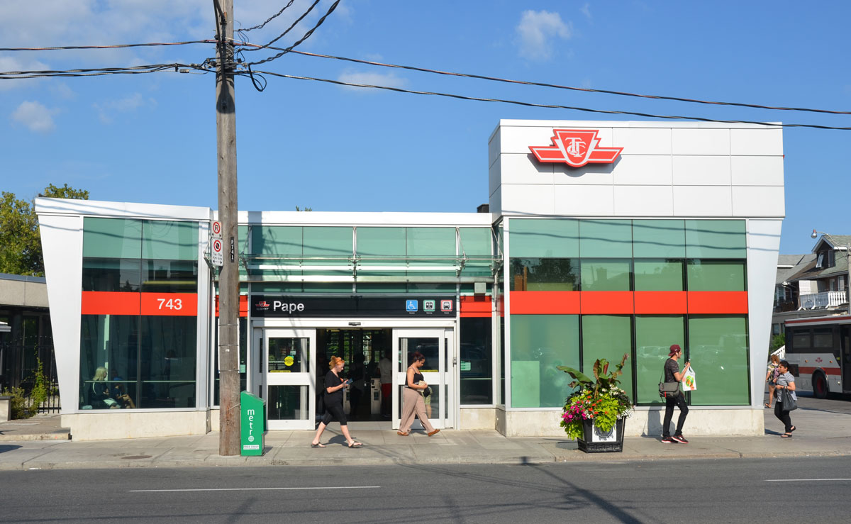 a view of the exterior of the newly renovated Pape Station, taken from across the street