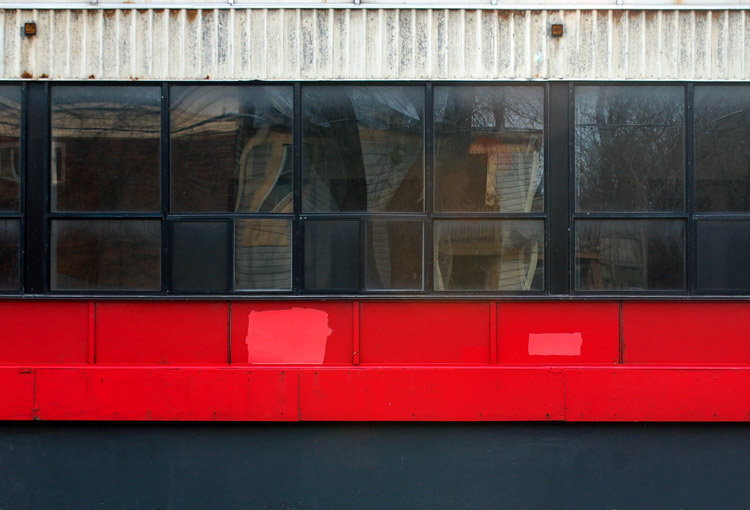 horizontal lines created by a line of windows with red on the bottom and white on the top