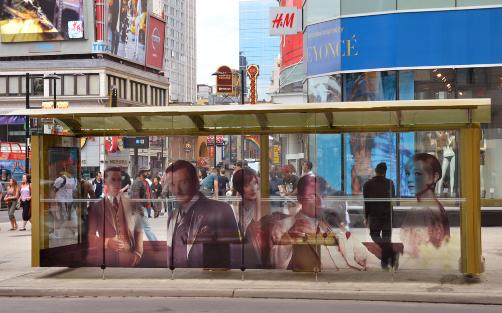streetcar stop shelter decorated with an ad for the movie The Great Gatsby