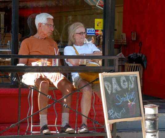 a couple in the open window of a restaurant