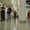 a view of the interior of lower Bay subway station of the TTC, with some people walking on the platform
